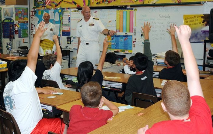US Navy Capt. Ricks Polk, commanding officer of Afloat Training Group Middle Pacific answers questions from students during a Career Day at Iroquois Point Elementary School, courtesy Wikipedia Commons.
