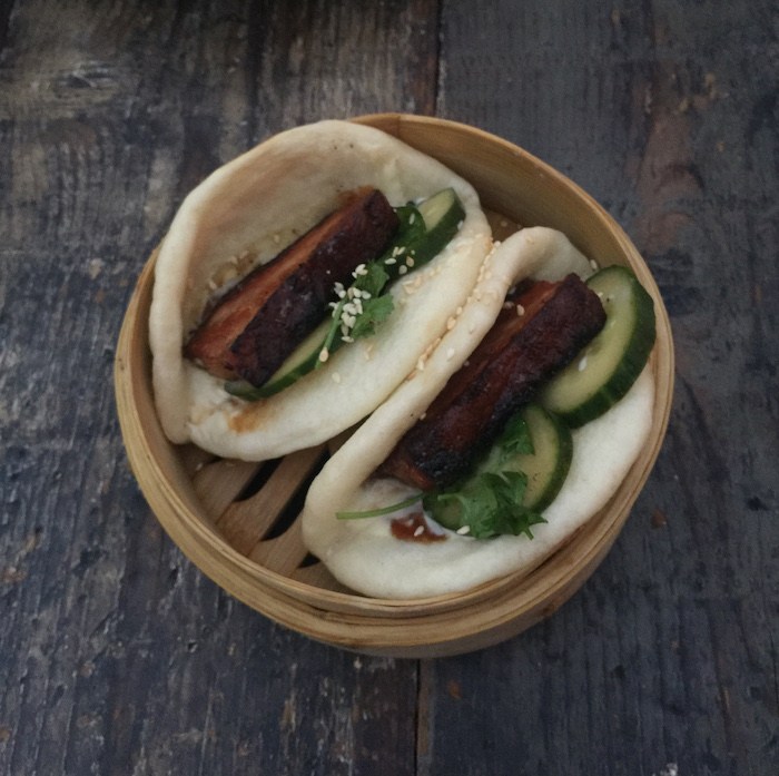 Outpost’s Pork Belly Bao Buns with Pickled Cucumber, Jalapeno Kewpie, Sesame Seed, Cilantro and Hoisin Sauce, photo by Leslie Dinaberg