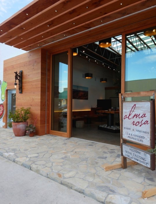 Alma Rosa’s eco-chic tasting room in Buellton, built by Allen Construction, incorporates a 15-foot olive tree, local river stone and recycled Douglas Fir. Photo by Patrick Price.